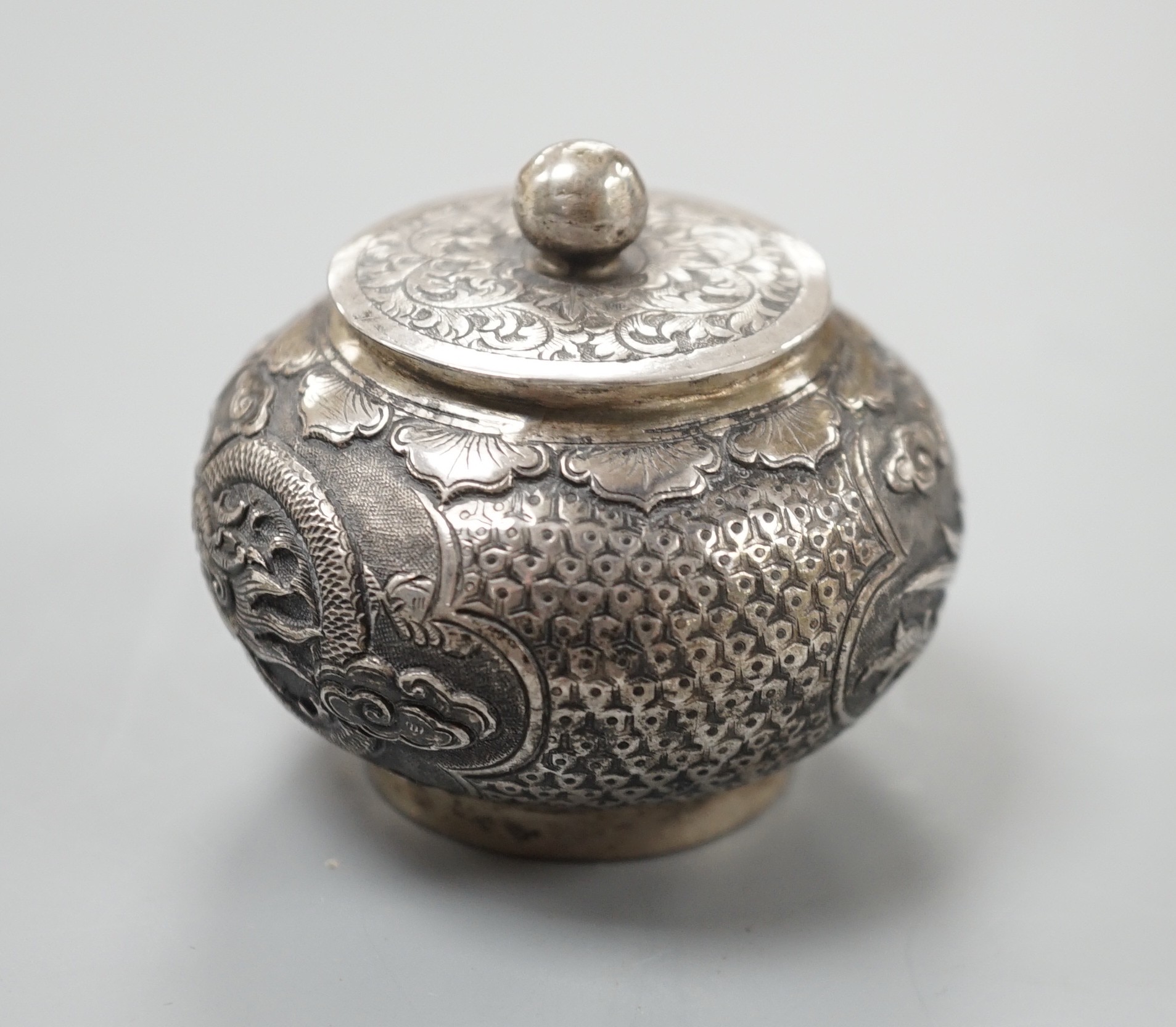 A Chinese white metal unsigned pot and cover, 5cms high.